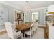 Bright dining room with oval table, chandelier, and hardwood floors at 50211 Manly, Chapel Hill, NC 27517