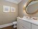 Modern bathroom with white vanity, gold accents, and textured wallpaper at 50211 Manly, Chapel Hill, NC 27517