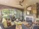 Relaxing sunroom with stone fireplace, wicker furniture, and abundant natural light at 50211 Manly, Chapel Hill, NC 27517