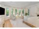 Bright bedroom with large windows, hardwood floors, and comfortable seating at 50211 Manly, Chapel Hill, NC 27517
