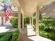 Brick walkway leading to a covered porch with lush landscaping at 50211 Manly, Chapel Hill, NC 27517