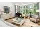 Sun-drenched living room with bay windows, piano and comfortable seating at 50211 Manly, Chapel Hill, NC 27517