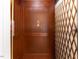 Elegant wood-paneled elevator with brass gate, adding a touch of class at 50211 Manly, Chapel Hill, NC 27517