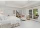 Bright bedroom with white bedding, French doors, and access to a view at 50211 Manly, Chapel Hill, NC 27517