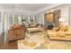Bright living room with stone fireplace, large windows, and ample seating at 50211 Manly, Chapel Hill, NC 27517