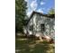 Side view of a modest white house with a brick foundation and AC unit at 4285 Belltown Rd, Oxford, NC 27565