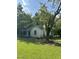Side view of a modest white house with a covered porch and mature trees at 4285 Belltown Rd, Oxford, NC 27565