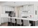 Modern kitchen with white cabinets, large island, and stainless steel appliances at 521 Impala Trce, Wendell, NC 27591