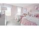 Cozy bedroom with two twin beds, light pink walls, and plenty of natural light at 521 Impala Trce, Wendell, NC 27591