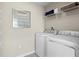 Bright laundry room with washer, dryer, and shelving at 521 Impala Trce, Wendell, NC 27591