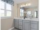 Double vanity bathroom with a large mirror and updated fixtures at 521 Impala Trce, Wendell, NC 27591