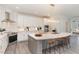 Modern kitchen with white cabinets, marble countertops, and large island at 600 Darian Woods Drive,, Holly Springs, NC 27540