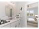 Bright bathroom with vanity, mirror, and view into bedroom at 600 Darian Woods Drive,, Holly Springs, NC 27540