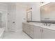 Elegant bathroom with double vanity, marble countertops, and large mirror at 600 Darian Woods Drive,, Holly Springs, NC 27540