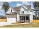 Stunning two-story home with stone and siding exterior at 600 Darian Woods Drive,, Holly Springs, NC 27540