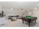 Relaxing game room with sectional sofa, pool table, and wet bar at 600 Darian Woods Drive,, Holly Springs, NC 27540