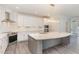 Modern kitchen with white cabinets, marble countertops, and stainless steel appliances at 600 Darian Woods Drive,, Holly Springs, NC 27540