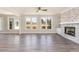 Open living room featuring a stone fireplace and wall-to-wall windows at 600 Darian Woods Drive,, Holly Springs, NC 27540
