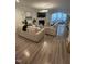 Spacious living room with light-colored sofas, a fireplace, and hardwood floors at 5011 Manderleigh Dr, Knightdale, NC 27545