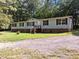 Single-story home with vinyl siding, brick base and a gravel driveway at 3186 Buckhorn Ln, Wake Forest, NC 27587