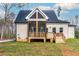 Back exterior of house featuring a screened porch and deck at 219 Sequoia Dr, Louisburg, NC 27549