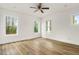 Spacious bedroom with hardwood floors and three windows at 219 Sequoia Dr, Louisburg, NC 27549