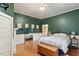 Spacious bedroom with dark green walls and hardwood floors at 214 College St, Oxford, NC 27565