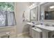 Bathroom with double vanity and a large mirror at 214 College St, Oxford, NC 27565