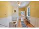 Upstairs hallway with hardwood floors and yellow walls at 214 College St, Oxford, NC 27565
