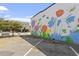 Vibrant floral wall mural in a parking area, adding vibrancy to the town at 214 College St, Oxford, NC 27565