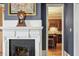Fireplace with mantel and view into kitchen at 214 College St, Oxford, NC 27565