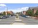 View down a town's main street, lined with shops and buildings, featuring parked cars at 214 College St, Oxford, NC 27565