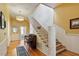 Grand entryway with hardwood floors, elegant staircase, and a piano at 214 College St, Oxford, NC 27565