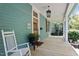 Inviting front porch with rocking chair and potted plants at 214 College St, Oxford, NC 27565