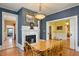 Dining room with hardwood floors, fireplace and kitchen view at 214 College St, Oxford, NC 27565