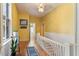 Upstairs hallway with hardwood floors and yellow walls at 214 College St, Oxford, NC 27565