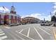 View of a town square with shops and parked cars at 214 College St, Oxford, NC 27565