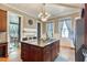 Kitchen with island, hardwood floors, and a view into dining area at 214 College St, Oxford, NC 27565