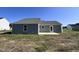 Gray house exterior with a back patio and grassy yard at 98 Lotus Ave, Smithfield, NC 27577