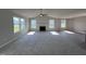 Spacious living room with a fireplace and large windows at 98 Lotus Ave, Smithfield, NC 27577