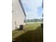 Large backyard with a view of a pond and neighboring houses at 1565 Sage Treee Dr Dr, Zebulon, NC 27597