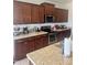 Well-equipped kitchen with ample counter space and dark wood cabinets at 1565 Sage Treee Dr Dr, Zebulon, NC 27597