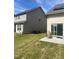 Backyard patio with adjacent houses and grassy area at 1565 Sage Treee Dr Dr, Zebulon, NC 27597