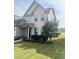 Two-story house with light beige vinyl siding, landscaping, and a well-maintained lawn at 1565 Sage Treee Dr Dr, Zebulon, NC 27597
