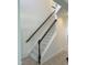Elegant staircase with dark wood railing and neutral carpeting at 1565 Sage Treee Dr Dr, Zebulon, NC 27597