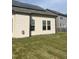 House exterior showcasing solar panels and a spacious lawn at 1565 Sage Treee Dr Dr, Zebulon, NC 27597