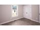 Bright bedroom with window, closet, and wood-look floors at 1845 N Main St, Roxboro, NC 27573