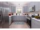 Modern kitchen with gray cabinets, stainless steel appliances, and quartz countertops at 1845 N Main St, Roxboro, NC 27573