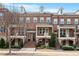 Brick three-story townhome with front porch at 836 Bankston Woods Way, Raleigh, NC 27609