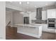 Modern kitchen with white cabinets, a large island, and stainless steel appliances at 836 Bankston Woods Way, Raleigh, NC 27609